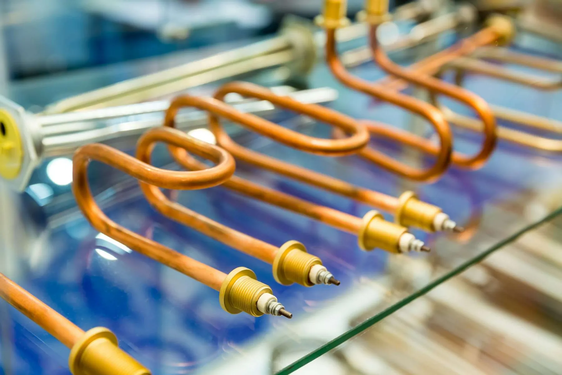 Copper heating tubes with gold tips on a glass surface