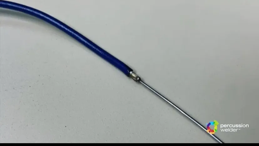 Blue insulated wire joined to a thin metal tube
