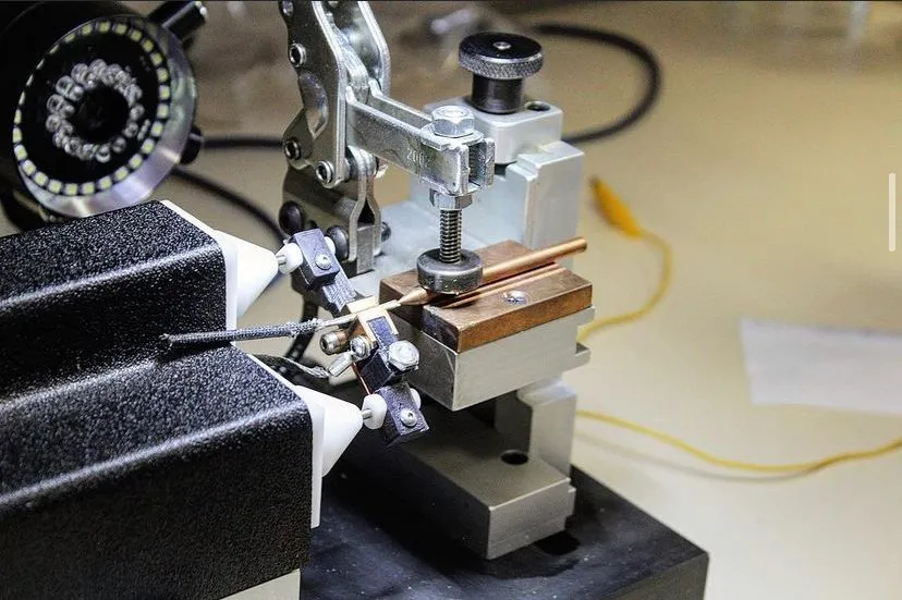 Bench fixture with ring light and a wire lead set between the electrode cones