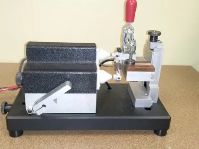 Model 726 bench fixture with toggle clamp on a tan surface