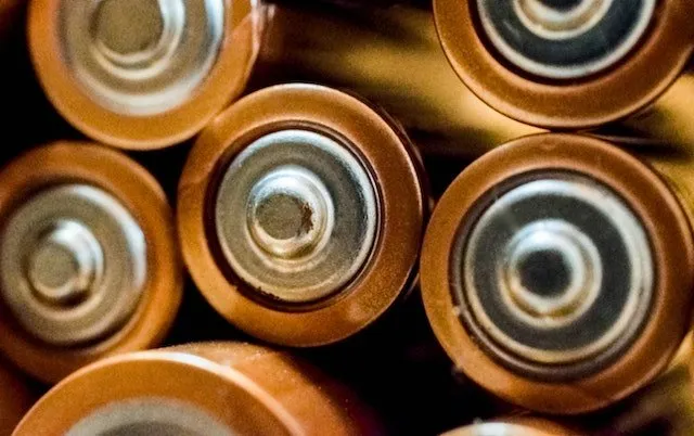 Close-up of the ends of several copper-toned battery cells