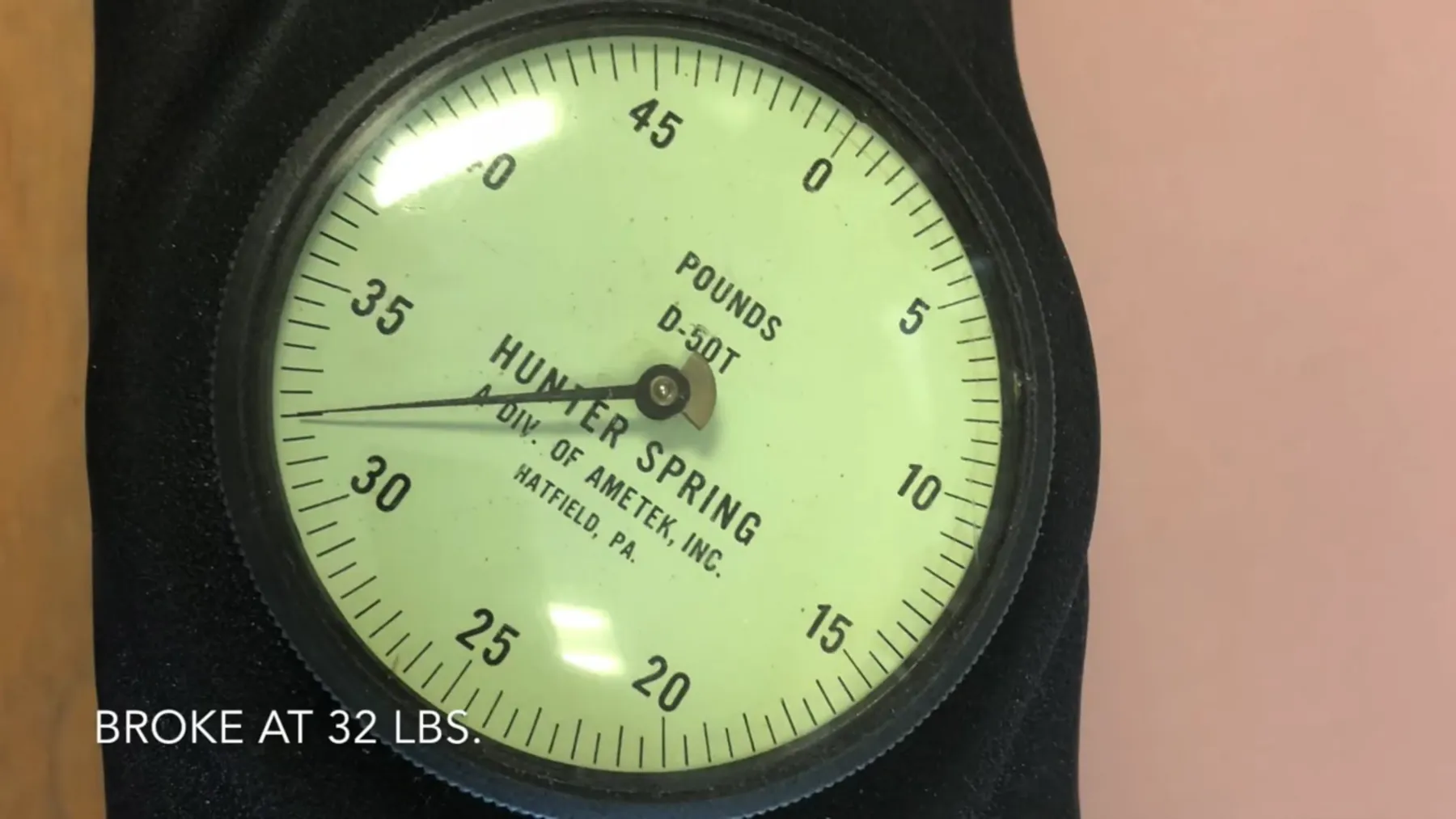 Dial pull gauge reading about 32 pounds, captioned Broke at 32 lbs